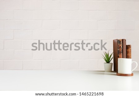 Mockup workspace desk and copy space books,plant and coffee on white desk. Royalty-Free Stock Photo #1465221698