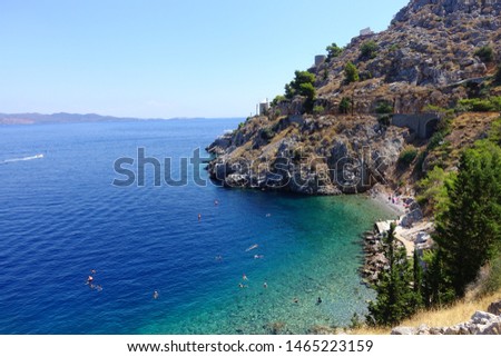Photo from paradise rocky beach of Avlaki next to picturesque port of Hydra island, Saronic gulf, Greece