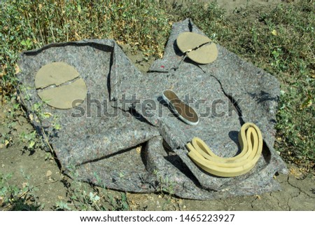 Abstract portrait of a man. Face on the ground. Strange eyes. Conceptual photography. Art installation.