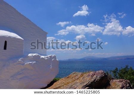 Photo of picturesque Greek chapel overlooking the sea located in Aegean island