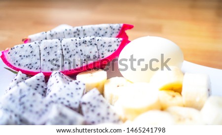 Dragon fruit, banana and boiled eggs 
Placed in a white plate. Concept 
Healthy food menu concept.