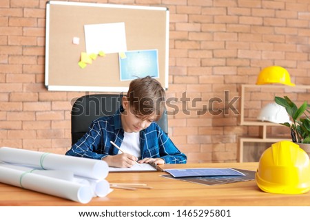 Cute little architect working in office
