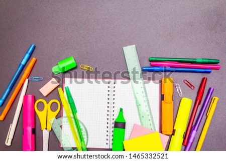 Back to school concept. School education supplies on black stone concrete background, copy space, top view