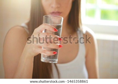 Young woman drinking pure glass of water stock photo