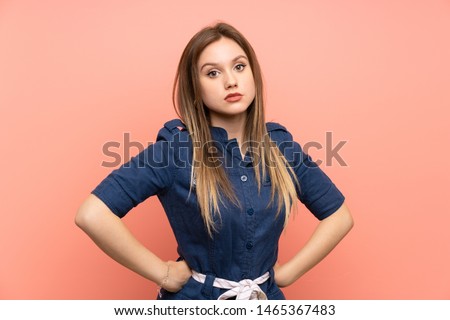 Teenager girl over isolated pink background angry