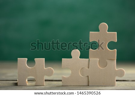 Creative solution for idea - business concept, jigsaw puzzle on the green blackboard background Royalty-Free Stock Photo #1465390526