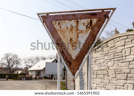 a rusty "give way" or "yield" road sign (in Slovakia)