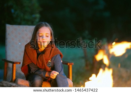 Beautiful girl bonfire rest nature danger of ignition