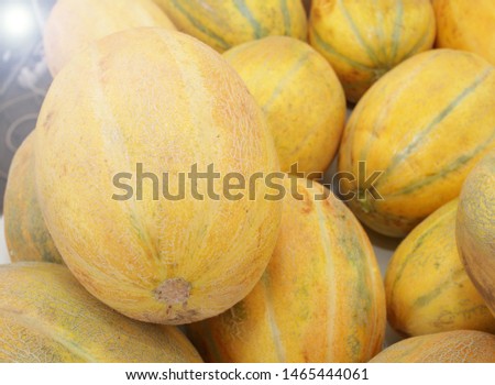 Melon, honey melon. Melons background texture. Fresh organic yellow fruits. Vegetarian or healthy eating concept.