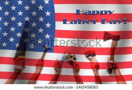 Happy Labor Day. Construction tools in the hands and the flag on the background and the inscription Happy Labor Day