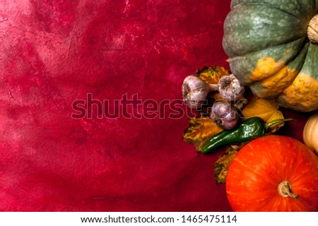 Hello Autumn. Top view - Orange, green and yellow pumpkins with fall leafs and vegetables on old textured background. Happy autumn time, free space for design