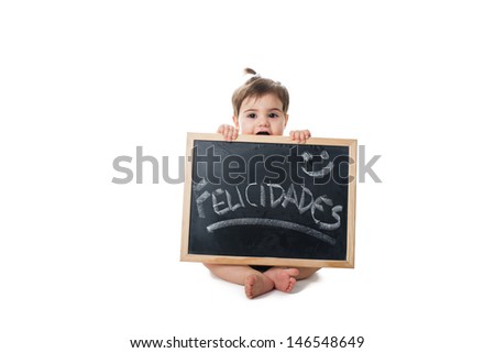 Baby holding a chalkboard with the word; felicidades hand write