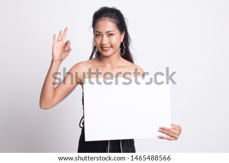 Young Asian woman show OK with white blank sign on white background