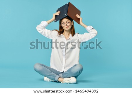 woman with laptop above head over blue background