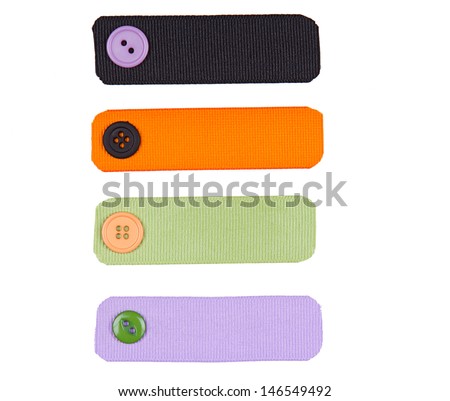 Halloween colored ribbon tags with sewing buttons isolated on white