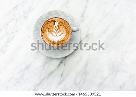 Cup of fresh coffee cappuccino with classic latte art and chocolate on white marble table trendy background. Empty place for text, copy space. Coffee addiction. Top view, flat lay.