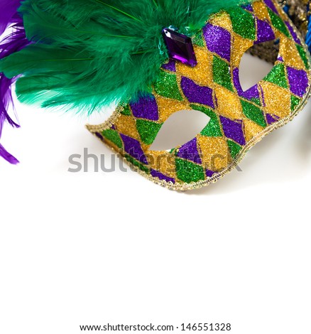 A glittery Mardi gras mask on a white background with copyspace
