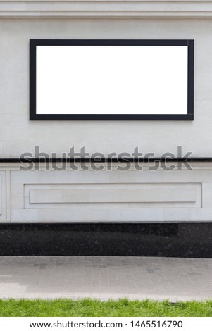 Blank billboard on a white wall. Vertically framed shot.