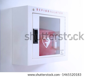 Automated External Defibrillator (AED) in white box on the wall Is an emergency pacemaker device for people with cardiac arrest. Heart defibrillator on white background. Royalty-Free Stock Photo #1465520183