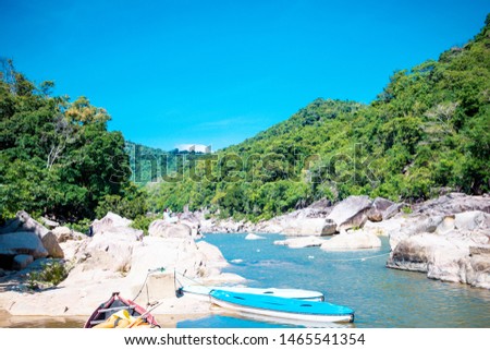 ecotourism destinations Ham Ho, stream with rock reflect on water surface and blye sky in Binh Dinh, Vietnam