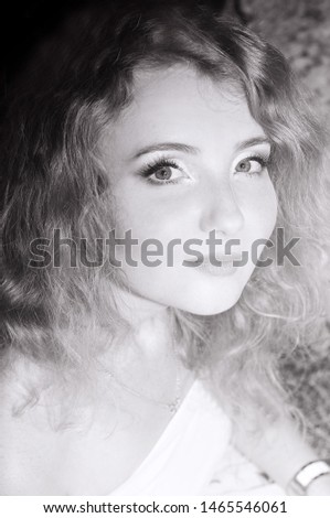 Black-white portrait of a beautiful girl with red hair and green eyes.