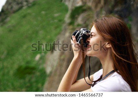 woman takes pictures of beautiful nature