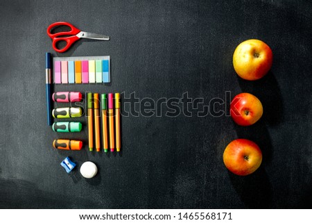 School blackboard background with stationery and autumn details.