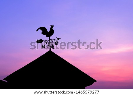 A weather vane, wind vane on the highest point of a building. Royalty-Free Stock Photo #1465579277