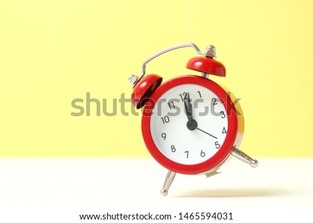 mechanical alarm clock on a colored background
