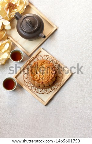 Mid Autumn festival. Moon cake and tea isolated with white texture background.Moon cake Chinese text translation:Pure bean paste