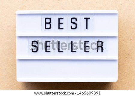 Lightbox with word best seller on wood background