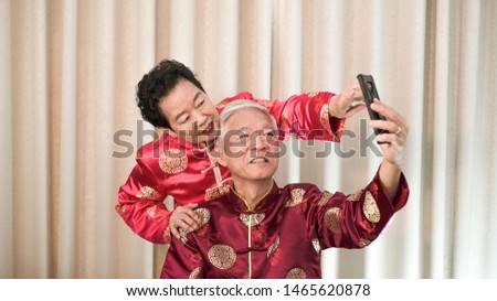 Asian senior couple selfie for Chinese New Year festival message