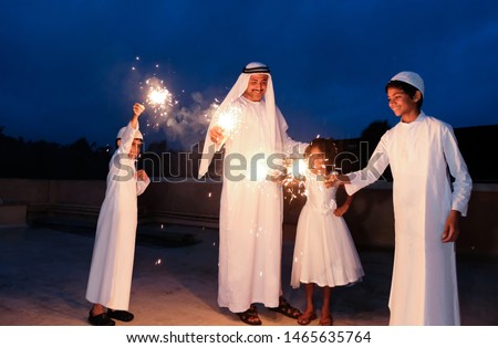 An arabic family  enjoying the sparkle of the festivity during festival celebration. Royalty-Free Stock Photo #1465635764
