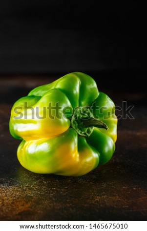 Sweet green pepper on dark background. Fresh yellow green bell pepper (capsicum)