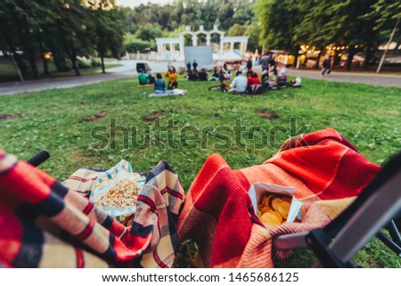 two folding chairs with cooling bag with beer and snacks in open air cinema copy space