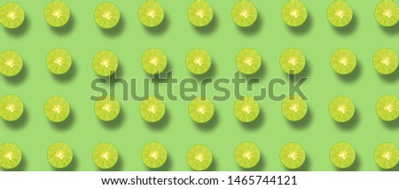 Many Lime placed together and isolated on a green background
