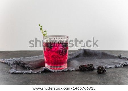 Blackberry fresh lemonade with ice in vintage glass top view 