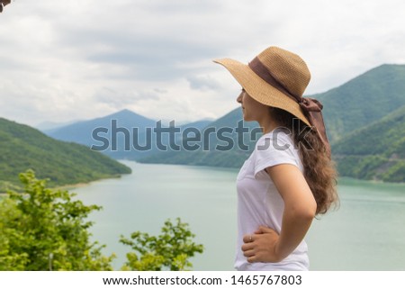 young woman in hat on a background of blue sky	
