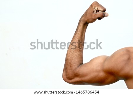 modern fashionable hairdo showing his huge big biceps strained arms isolated