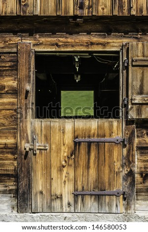 Picture of a wooden door of a stable in the Alps