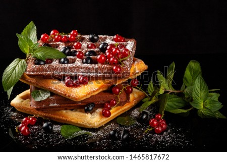 Freshly baked Viennese waffles on a black table