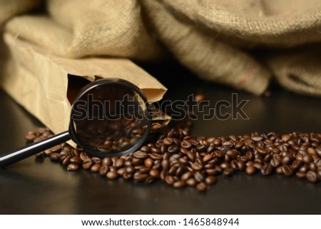 Cup of coffee, bag and scoop on old rusty background