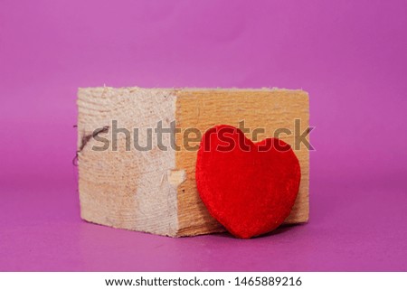 Red throw pillow heart shape with big 3d wooden cube, isolated on white with clipping path