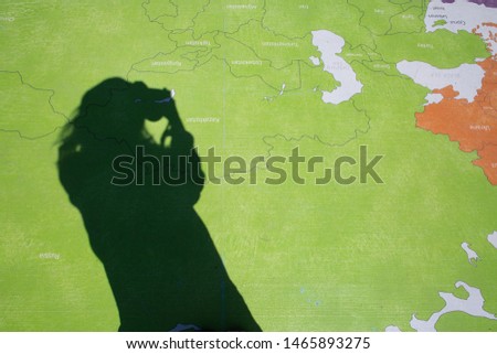 person shadow reflection world map wood deck photographer minimal style 