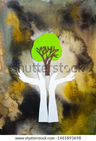 Human's hand carefully holding tree. Eco and Environmental concept. Paper cut design background.