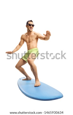 Full length shot of an attractive young surfer on a surfboard isolated on white background