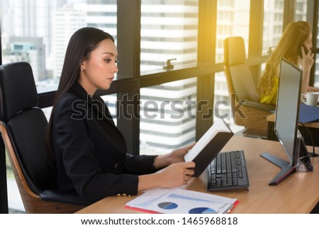 Business woman working with laptop computer.creative business people planning at modern work office .Successful Businesswoman in elegant black suit working with computer sitting at table in the office