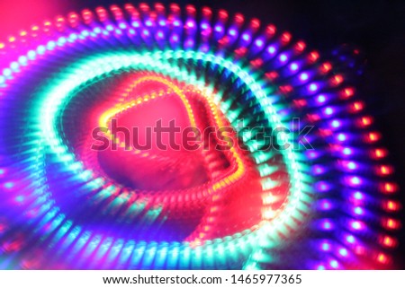 Moving, spinning led lights. Abstract idea of the atom’s nucleus and orbiting electrons as an electron cloud.  Royalty-Free Stock Photo #1465977365