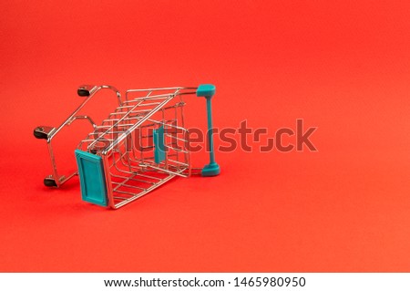 empty shopping cart on bright red background