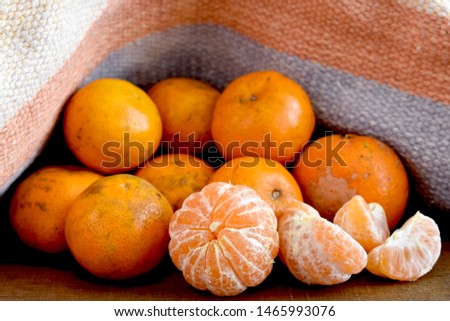 The mini Tangerines on a wooden table with a rustic color background